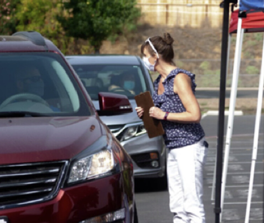 Woman providing drive-up services